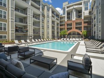 A swimming pool in front of an apartment building